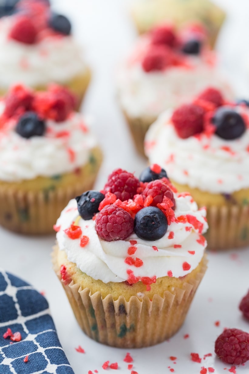 Patriotic cupcakes with crackling Pop Rocks and fresh toppings. Firecracker cupcakes topped with whipped cream, red and blue berries, and Pop Rocks.
