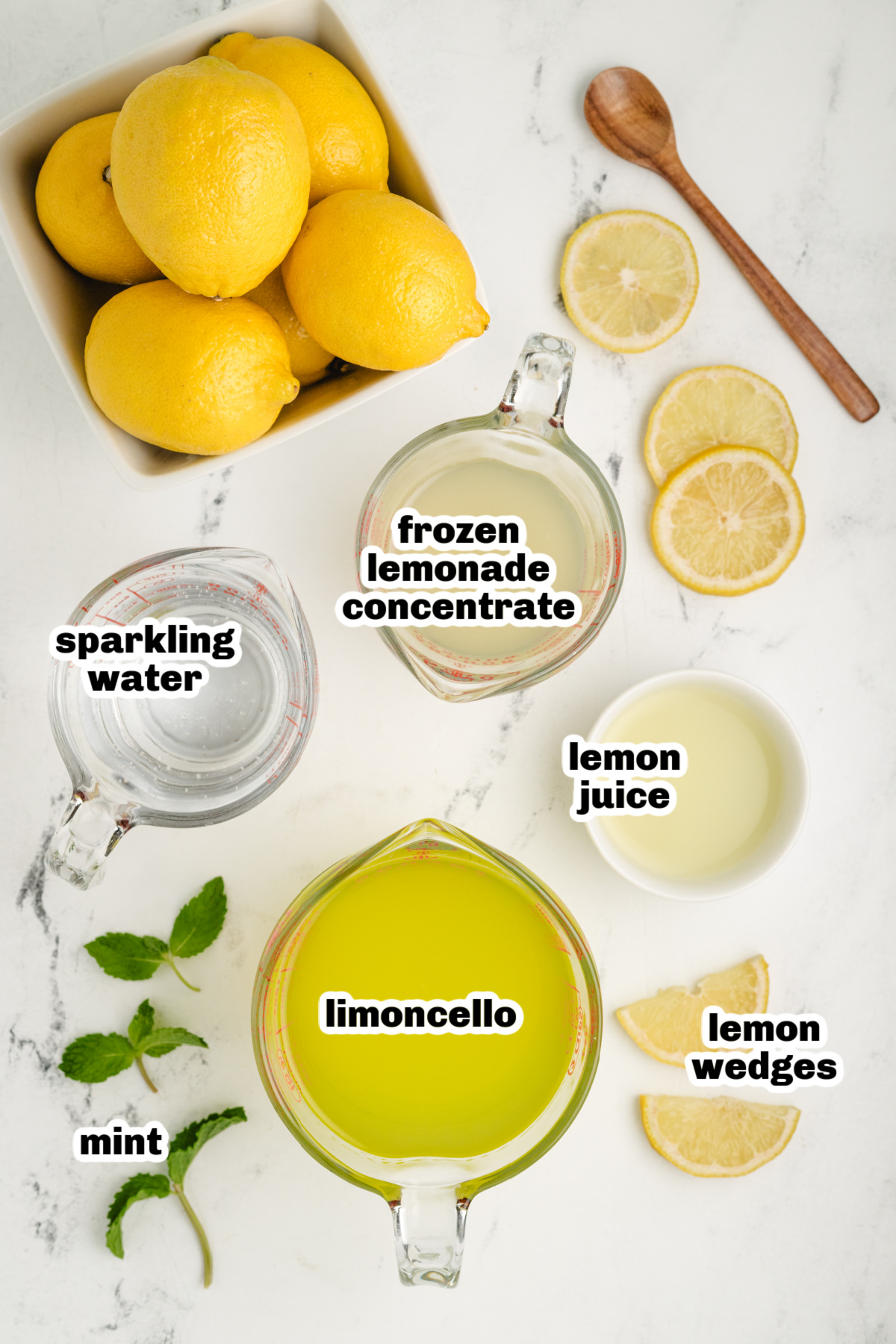 limoncello cocktail ingredients ingredients for a sparkling limoncello cocktail with frozen lemonade concentrate, lemon juice, mint, and sparkling water