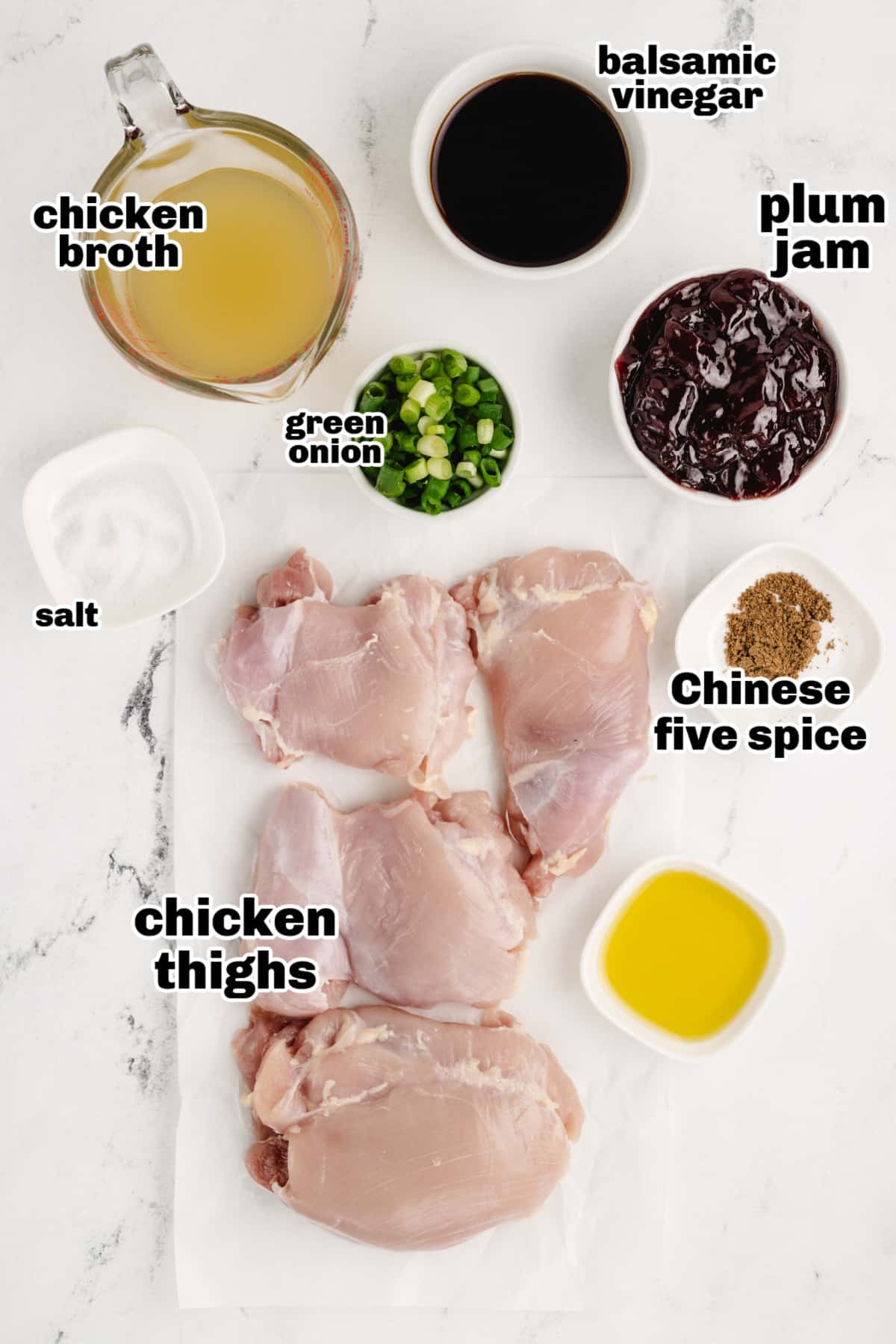 Saucy Plum Chicken ingredients Overhead view of ingredients for this recipe including boneless chicken thighs, plum jam, balsamic vinegar, green onions, and seasonings.