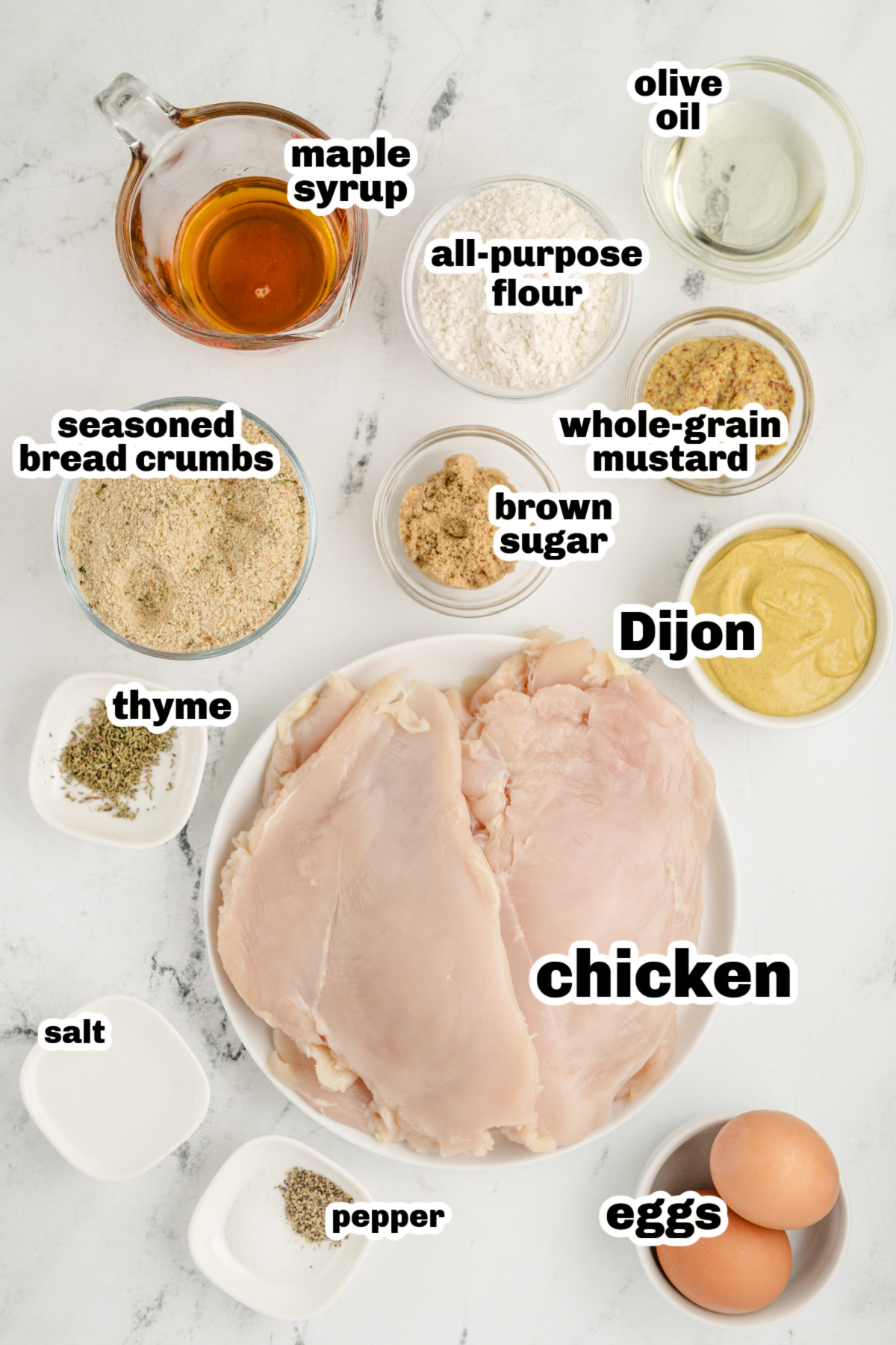 Ingredients for Crispy Glazed Chicken Cutlets Ingredients for making maple mustard glazed chicken cutlets laid out on a white surface