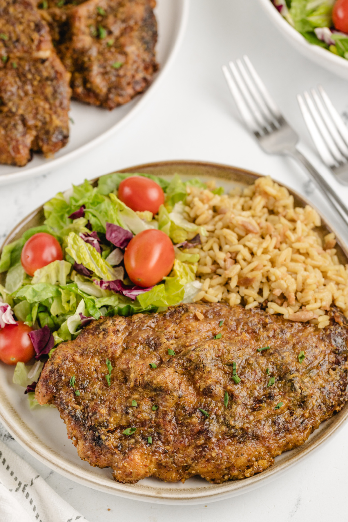 Crispy Chicken Cutlet with Maple Mustard Glaze and Sides Crispy maple mustard glazed chicken cutlet served with salad and seasoned rice
