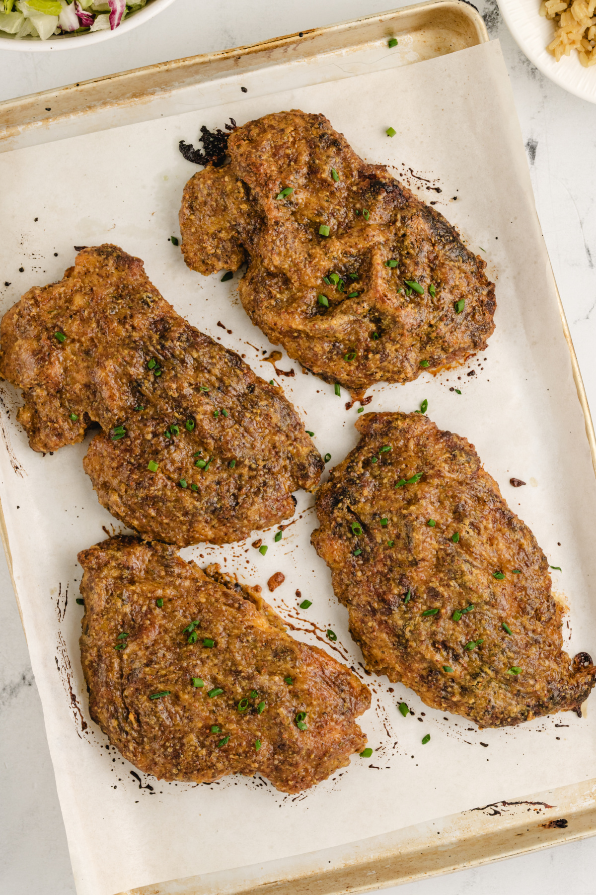 Baked Chicken Cutlets with Maple Mustard Coating Oven-baked chicken cutlets glazed with maple and mustard on parchment-lined tray