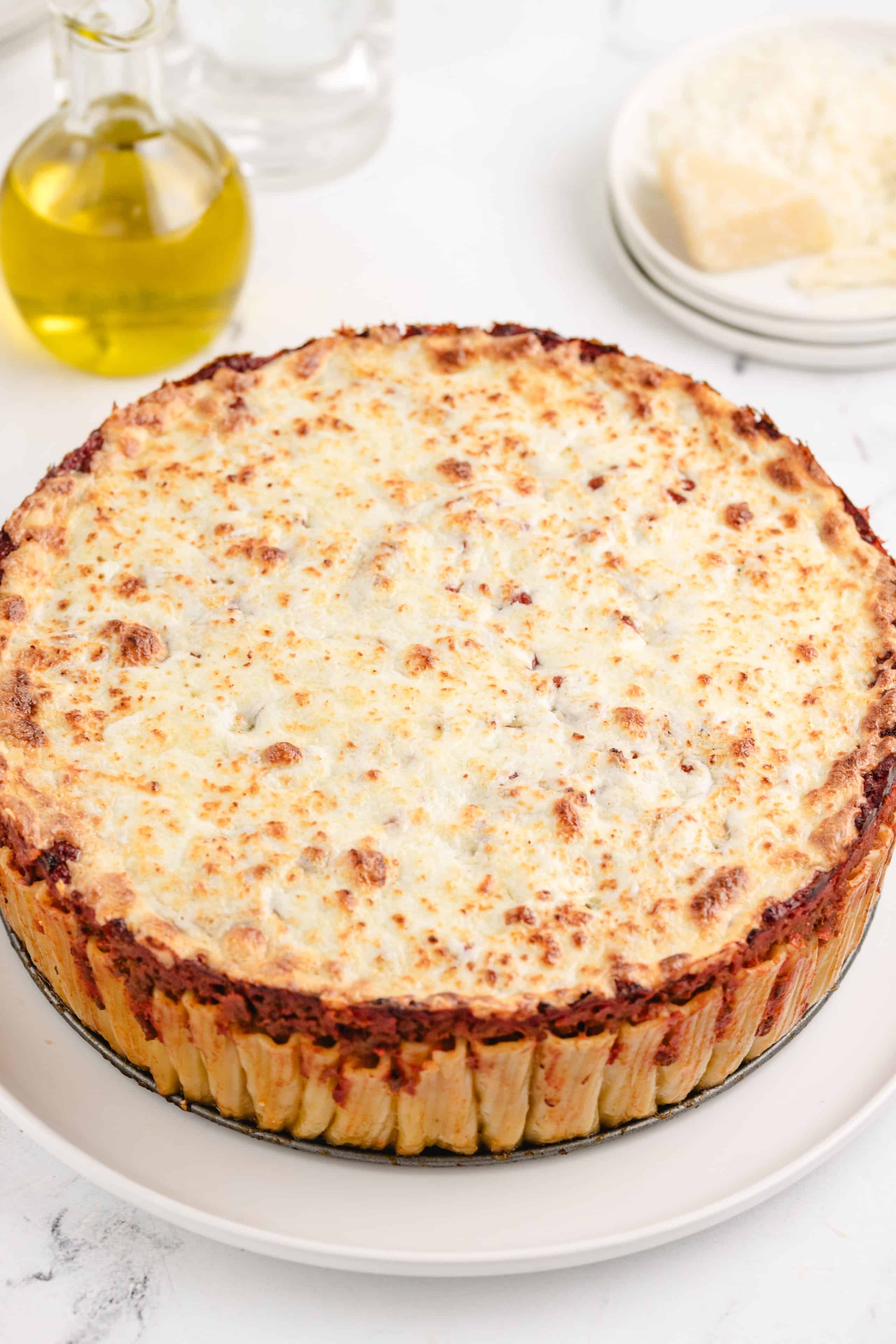 Pasta Pie top view shot top view of the pasta pie showing the structured rigatoni packed with rich meat sauce and topped with golden, melted cheese.