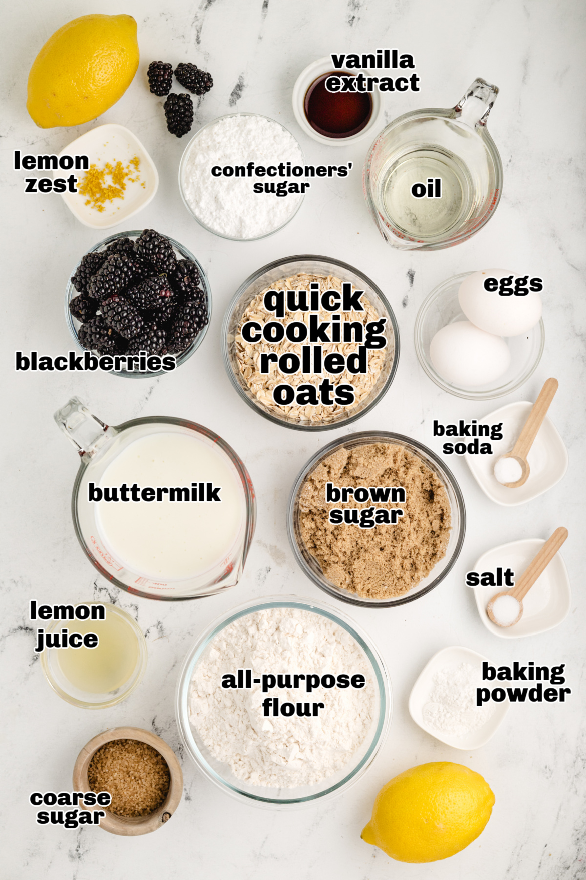 baking ingredients for oat muffins with blackberries and lemon glaze measured ingredients for lemon blackberry oat muffins including buttermilk, flour, and fresh berries