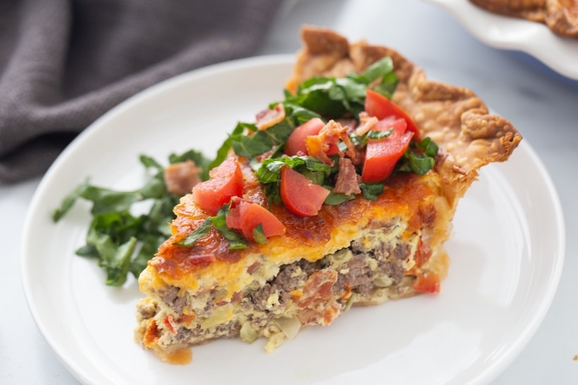 A Cheeseburger Quiche that tastes just like the hamburger you've been craving. Packed with ground beef protein and bacon, this quiche is the best! slice of ground beef quiche
