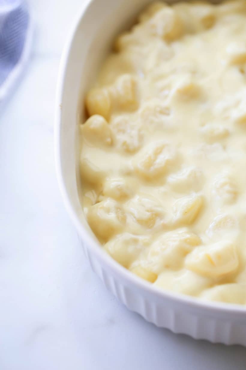 The Best Gnocchi Mac and Cheese - a mouth-wateringly complex blend of flavors. You are going to flip over the savory, richly-layered gnocchi cheese sauce in every bite. cheese sauce poured over top in a serving dish.