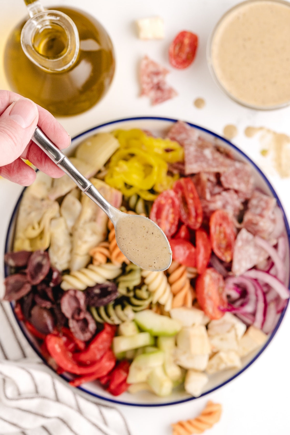 Every bite of this antipasto pasta salad, with its tangy red wine vinaigrette, crunchy cucumbers, salami, Kalamata olives, and especially the smoked mozzarella, offers something different and tastes amazing. tangy red wine vinaigrette