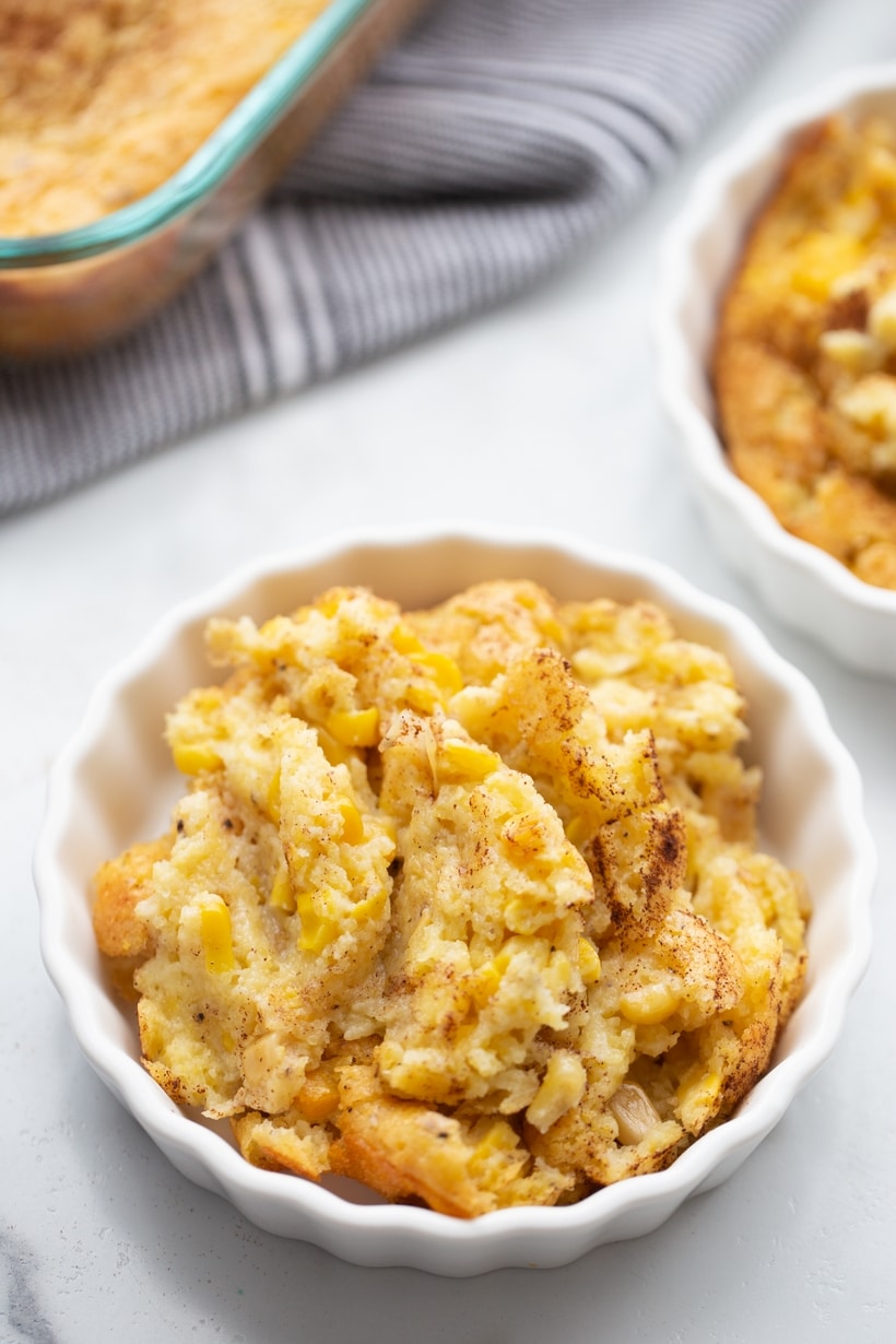 Corn pudding ready to eat Close-up shot of corn pudding in a fluted ramekin, capturing the soft, custardy center.