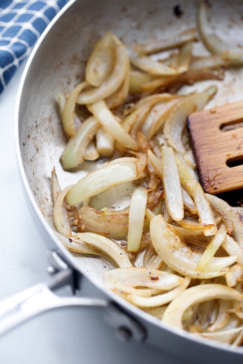 Vietnamese-Style Beef - an easy and absolutely delicious weeknight meal you need to feed your family! All the flavors, both sweet and savory, of garlic, pepper and lime come shining through. sautéed onions in a pan