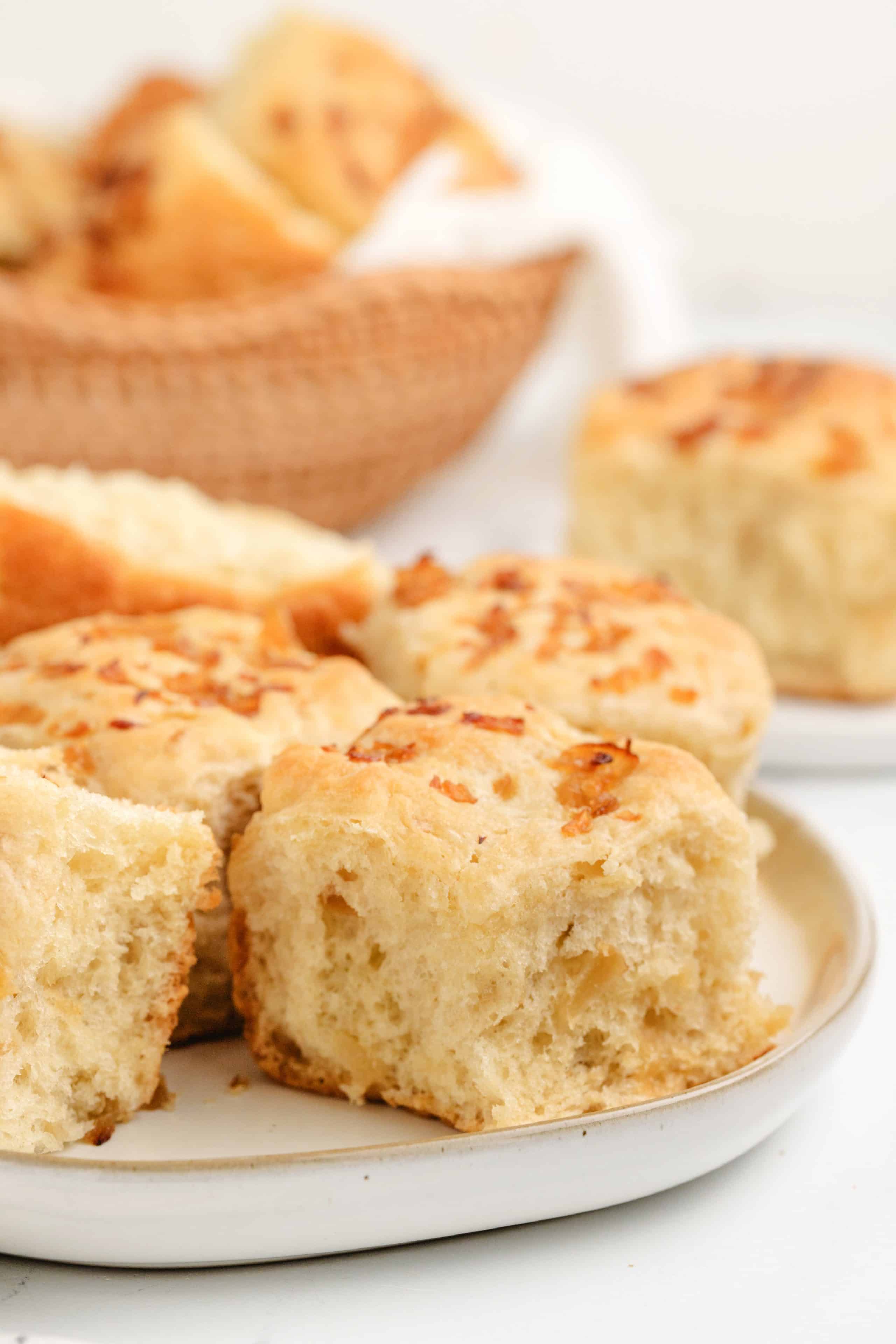A plate with a few onion rolls, showing their soft texture and caramelized onion topping.