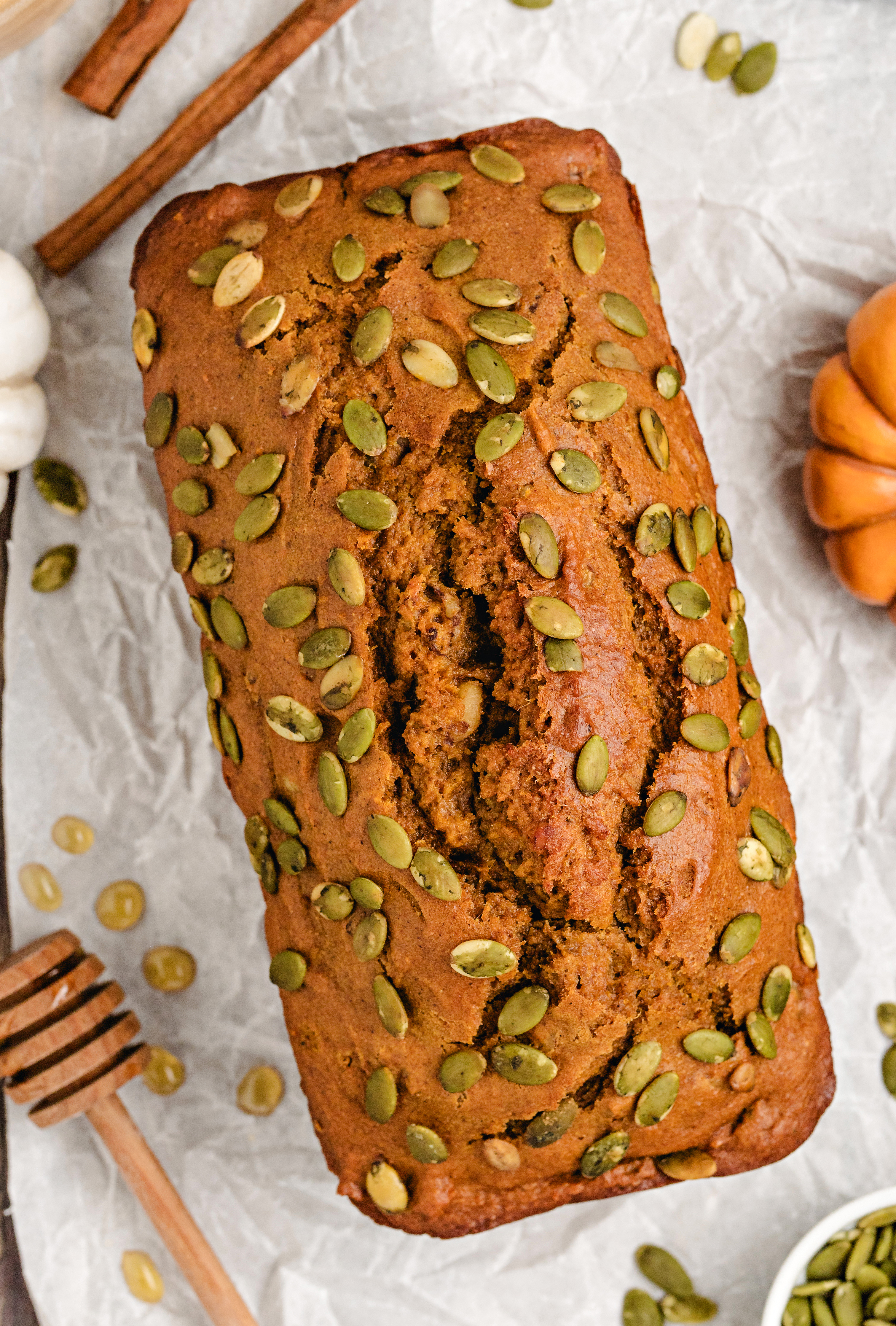Lightened-up pumpkin bread loaf topped with pepitas.