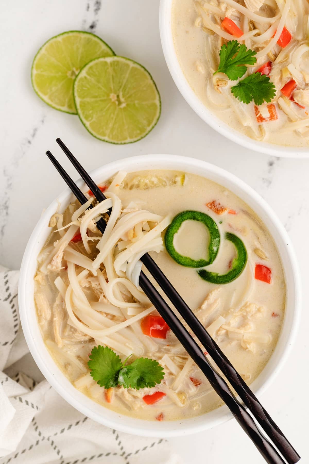 Slow Cooker Thai Chicken Noodle Soup eaten with chopsticks Slow Cooker Thai Chicken Noodle Soup overhead with chopsticks