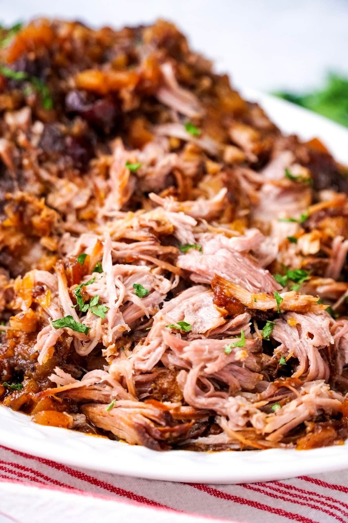 Slow Cooker Cranberry-Pineapple Pork Pork with cranberry-pineapple sauce, served on a dish.