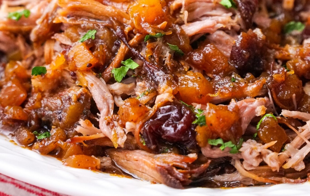 Close-up of pork with cranberry-pineapple sauce. Juicy pork slices topped with sweet cranberry-pineapple sauce.