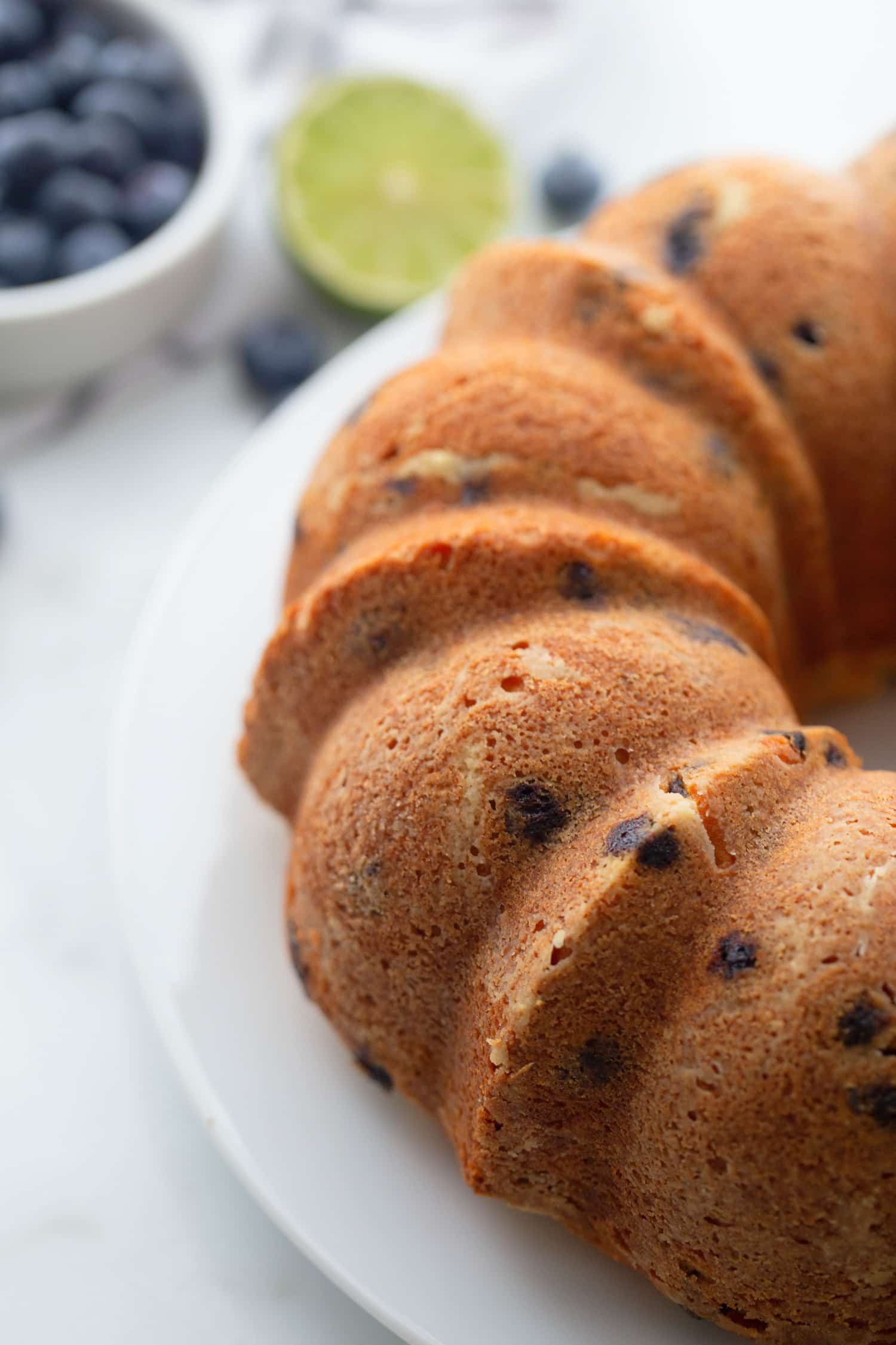 unglazed Blueberry-Lime Pound Cake Freshly baked blueberry-lime pound cake cooling on a wire rack, golden brown with no glaze.