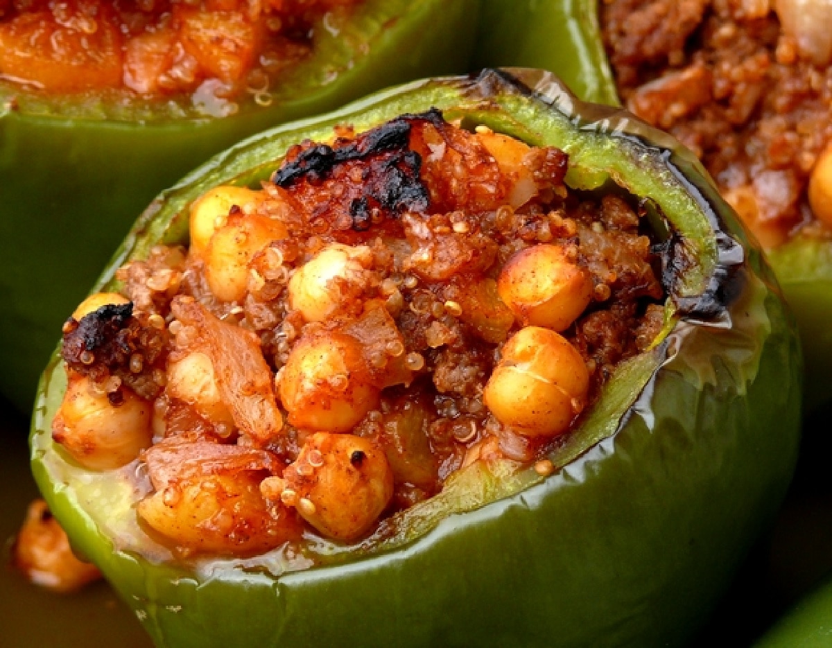 Mediterranean-Style Stuffed Peppers Overhead shot of Mediterranean-Style Stuffed Peppers with a golden, slightly charred top, highlighting the vibrant colors and hearty filling.