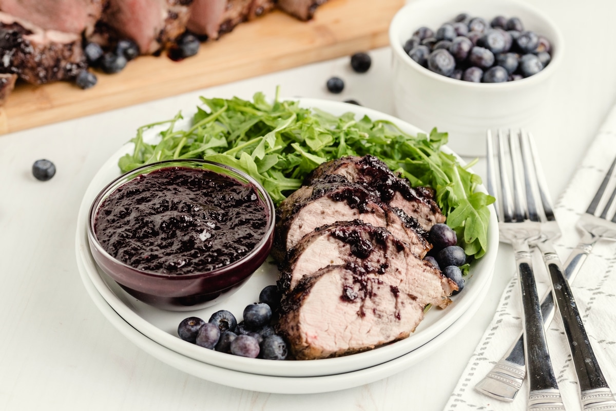 Pork tenderloin on a bed of greens.