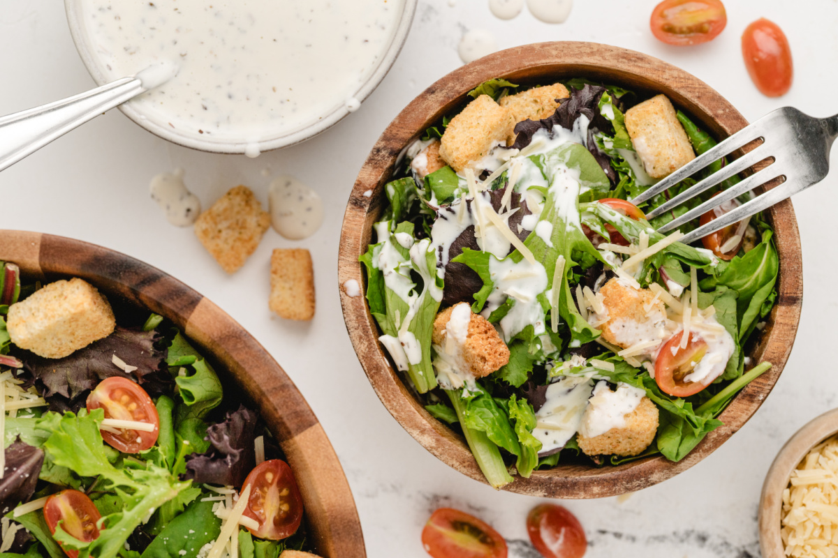Creamy Pesto Salad Dressing Like Spaghetti Factory Mixed greens and croutons topped with creamy pesto salad dressing in a wooden bowl