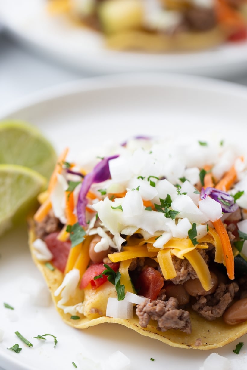 Chipotle Beef Tostadas - crunchy tortillas topped with a flavor packed beef and veggie mixture. This is an easy last minute meal that feels a little more sophisticated. chipotle beef