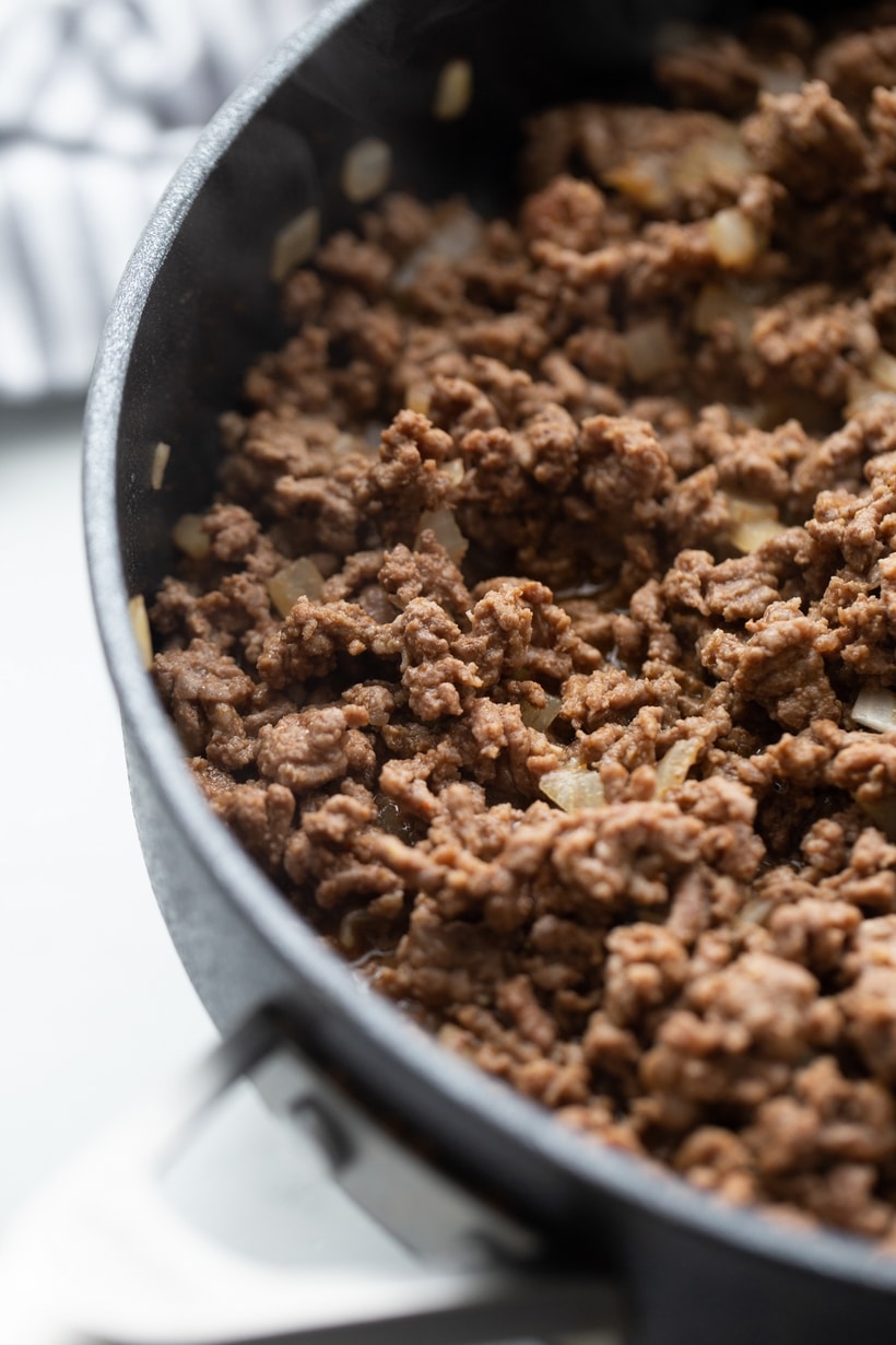 Cooked ground beef and onion mixture browned in skillet