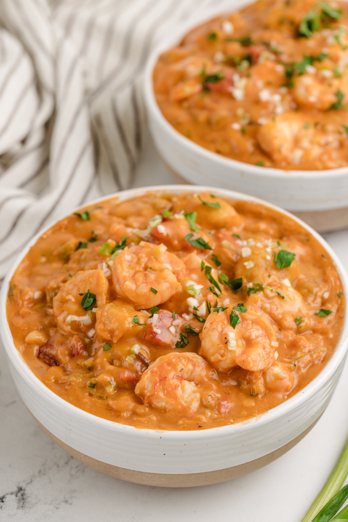 Creamy Shrimp Creole Soup with Bacon-Cornmeal Dumplings in bowls Creamy Shrimp Creole Soup with Bacon-Cornmeal Dumplings in two white bowls