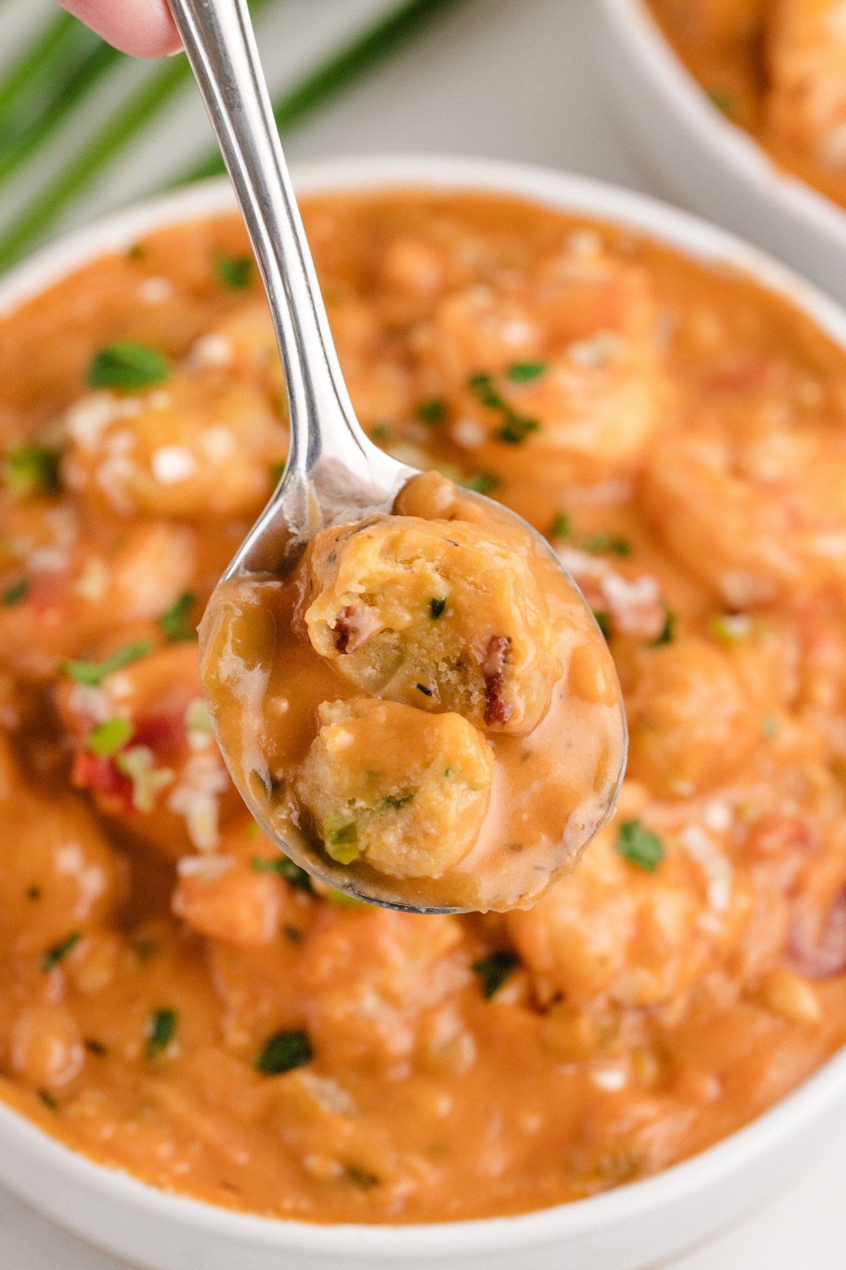 Creamy Shrimp Creole Soup with Bacon-Cornmeal Dumplings soup and dumplings in a spoon