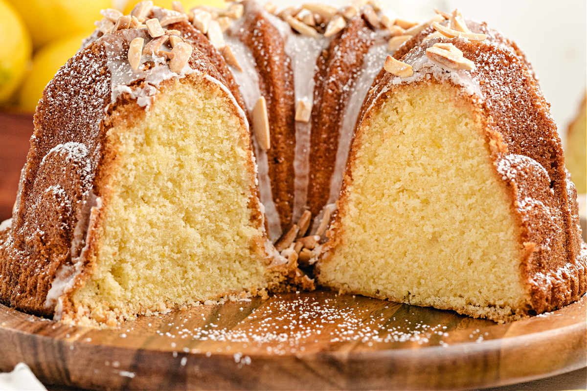 Limoncello Syrup Lemon Bundt Cake with Glaze and Almonds Limoncello Bundt cake sliced open to show soft lemon crumb and almond glaze