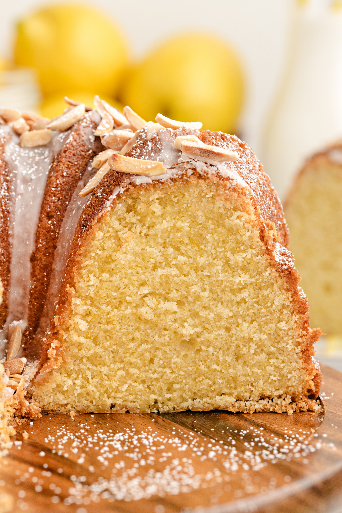 Moist Interior of Limoncello Bundt Cake Thick slice of lemon Bundt cake with a tender, moist crumb and powdered sugar