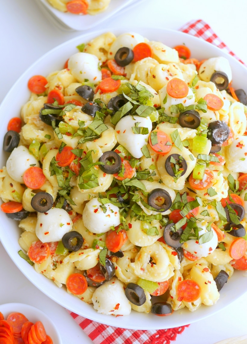 Bursting with bold flavors and with a pizza-inspired twist, this Pepperoni Pasta Salad is the perfect dish for any upcoming get-together. The tender pasta, juicy tomatoes, savory pepperoni, and zesty Italian dressing tie it all together in one delicious pizza pasta salad recipe. pizza pasta salad