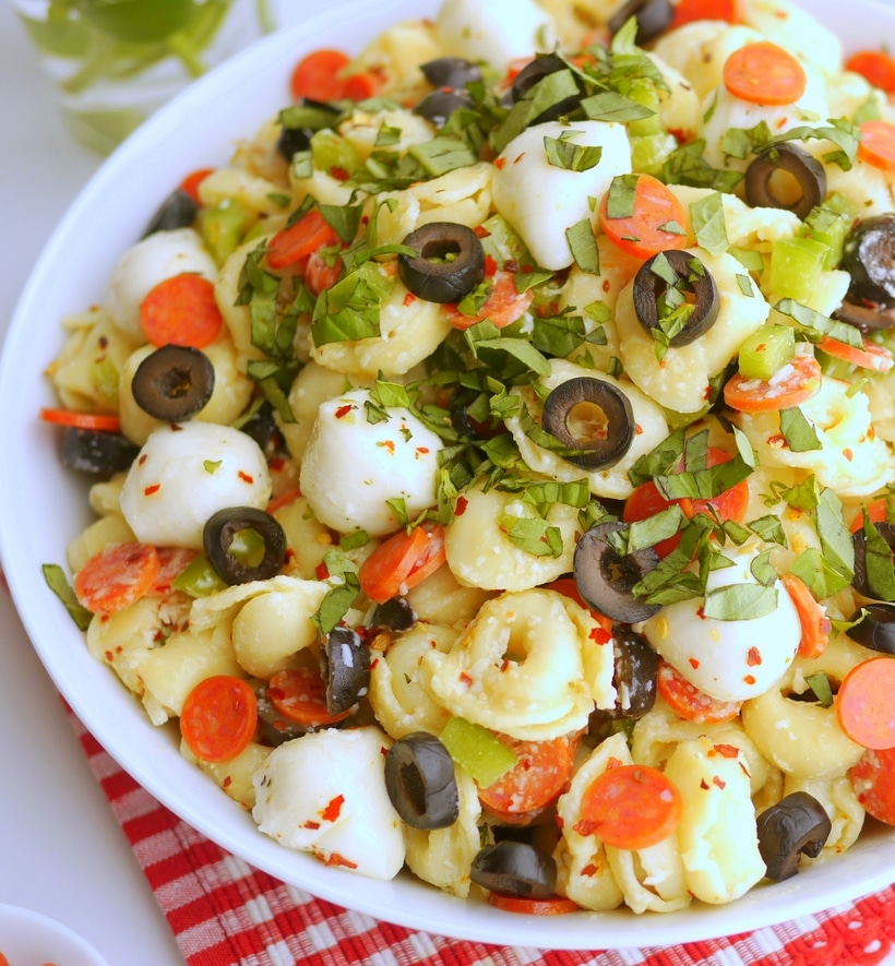 Bursting with bold flavors and with a pizza-inspired twist, this Pepperoni Pasta Salad is the perfect dish for any upcoming get-together. The tender pasta, juicy tomatoes, savory pepperoni, and zesty Italian dressing tie it all together in one delicious pizza pasta salad recipe. Italian pasta salad with pepperoni