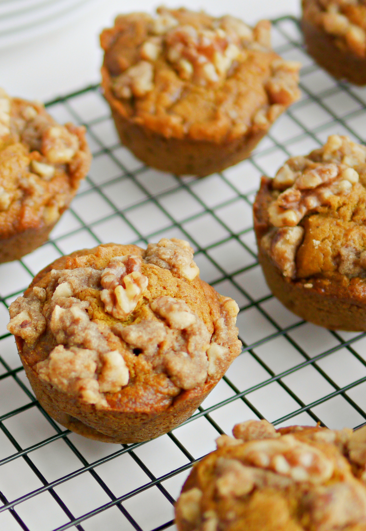 Easy Pumpkin brown sugar muffins with walnut crumble cooling on a wire rack.