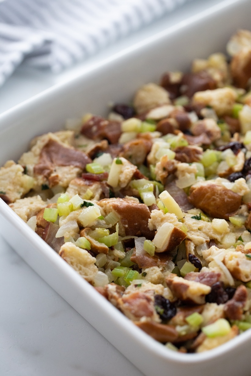 Unbaked Pretzel Bread Stuffing Ready for Oven Unbaked pretzel bread stuffing mixture spread evenly in a white baking dish.