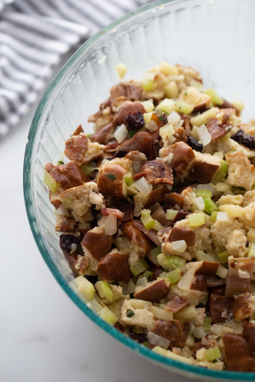 Unbaked Pretzel Bread Stuffing Unbaked pretzel bread stuffing mixture in a clear glass bowl.