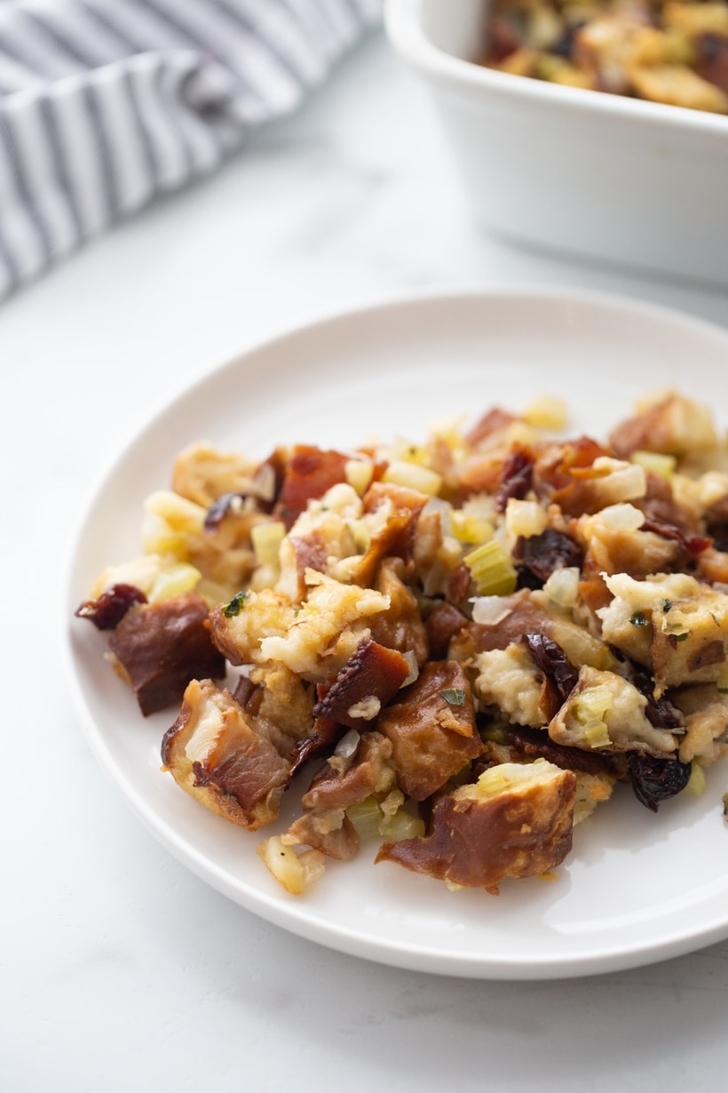 Plated Serving of Pretzel Bread Stuffing Serving of pretzel bread stuffing on a white plate.