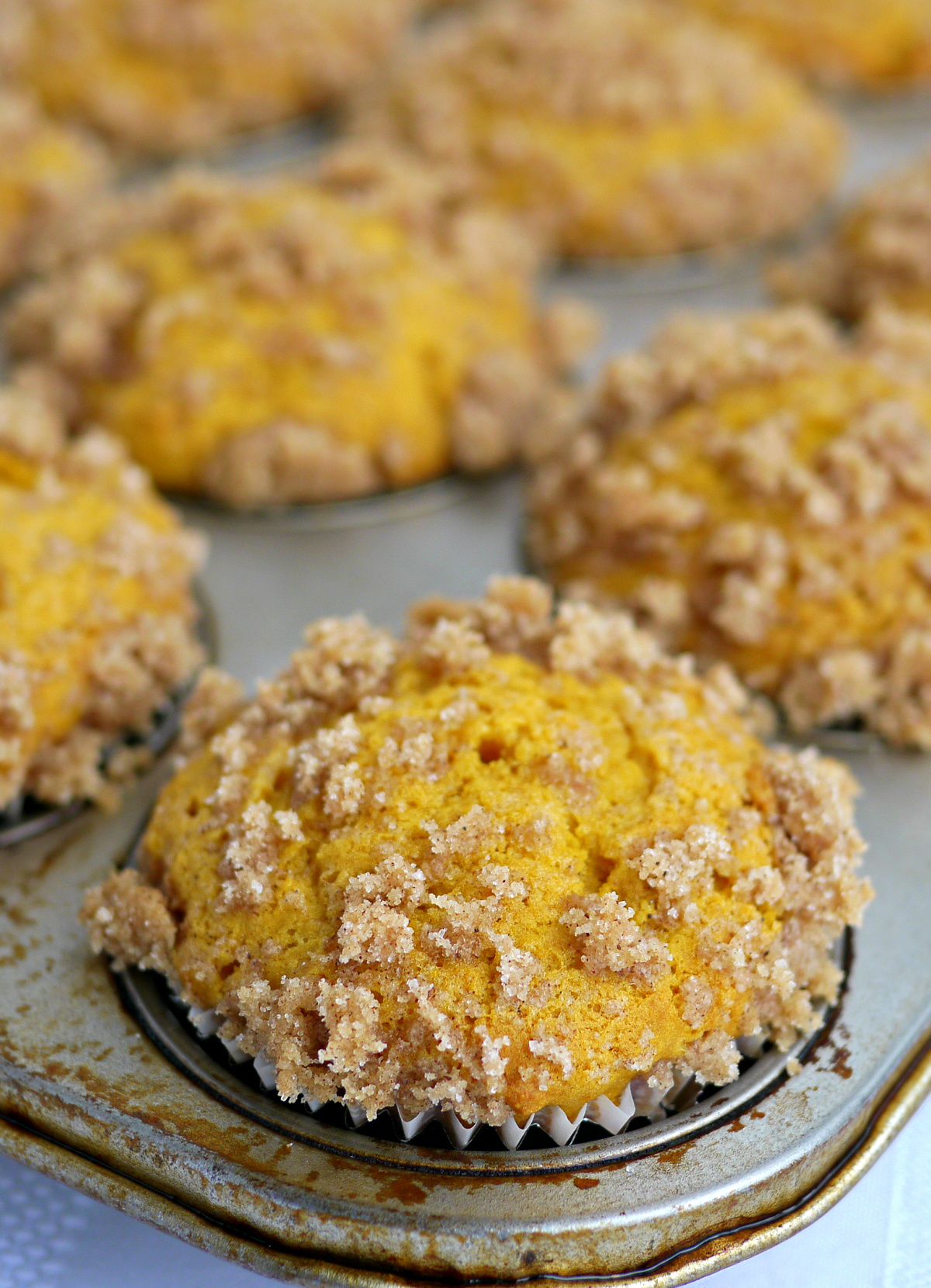 pumpkin muffin recipe with buttermilk and streusel topping cooling in metal muffin tin