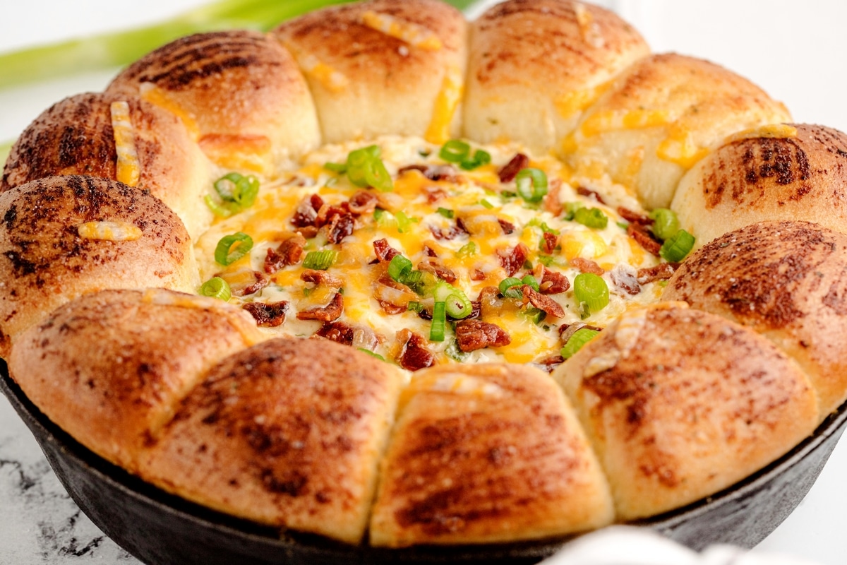 Sour cream bacon ranch ring dip served in a cast iron skillet