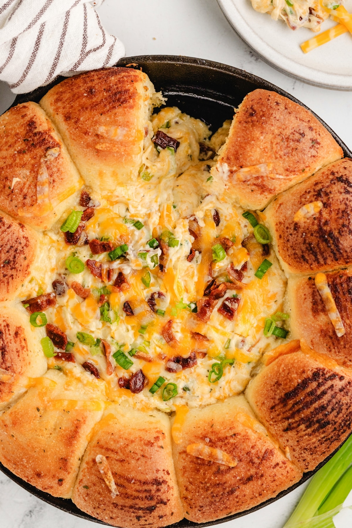 Sliced portion of sour cream bacon ranch ring dip showing creamy interior and crispy bacon topping.