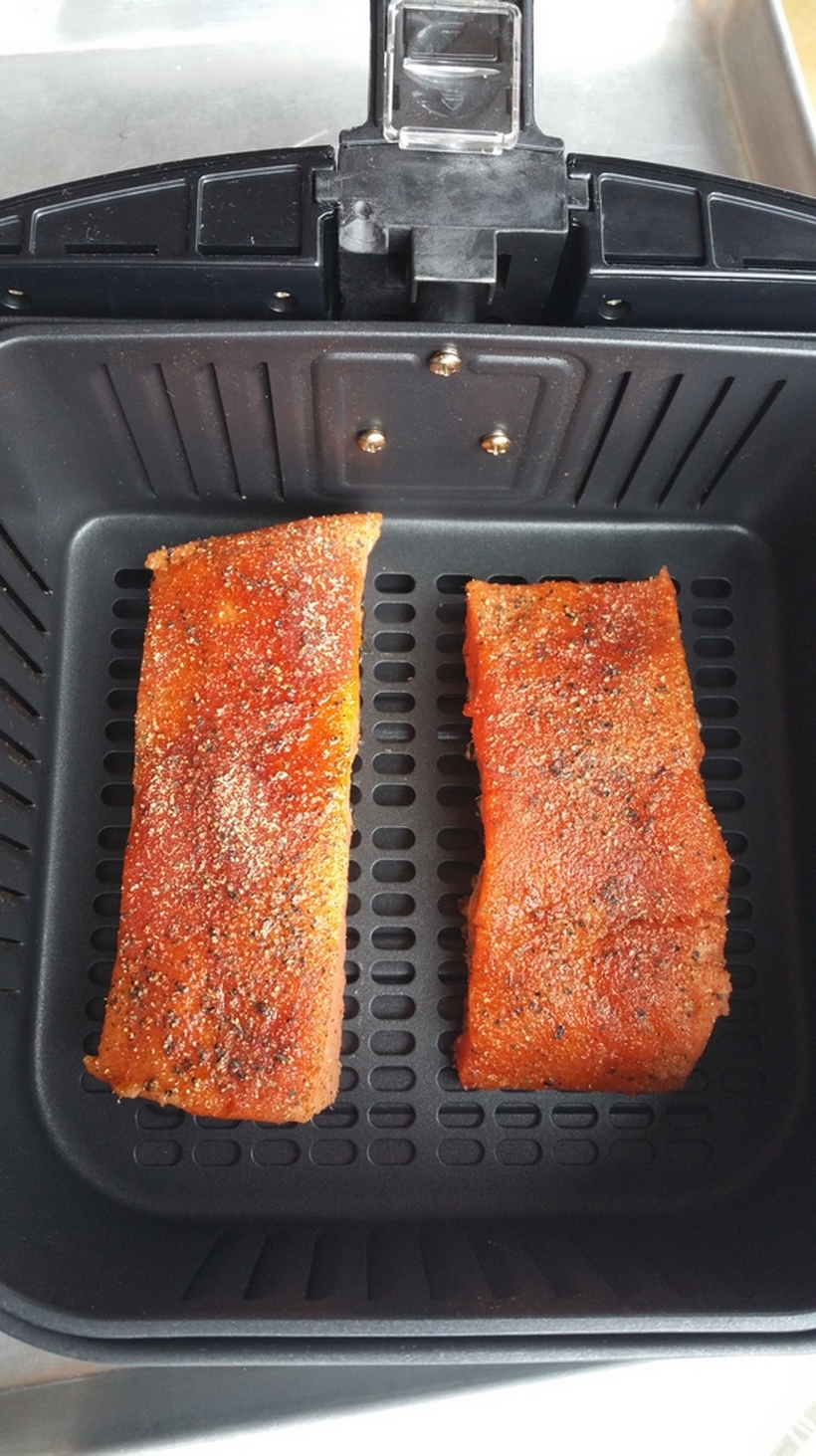 I would have never guessed making salmon in an air fryer would have produced the most tender and juicy salmon every time. I promise this Perfect Air Fryer Salmon will become your new way to conquer salmon in the kitchen from NoblePig.com. #airfryer #airfryerrecipe salmon fillets in an air fryer basket