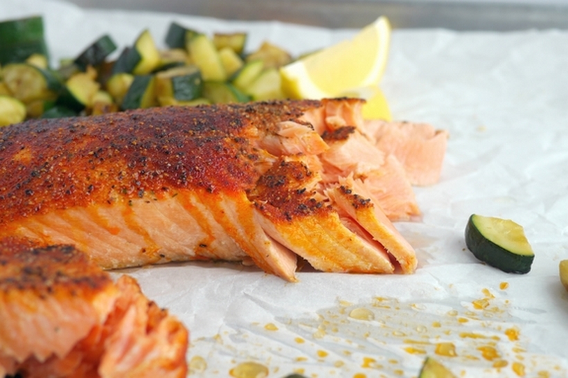 I would have never guessed making salmon in an air fryer would have produced the most tender and juicy salmon every time. I promise this Perfect Air Fryer Salmon will become your new way to conquer salmon in the kitchen from NoblePig.com. #airfryer #airfryerrecipe Two pieces of salmon surrounded by vegetables.
