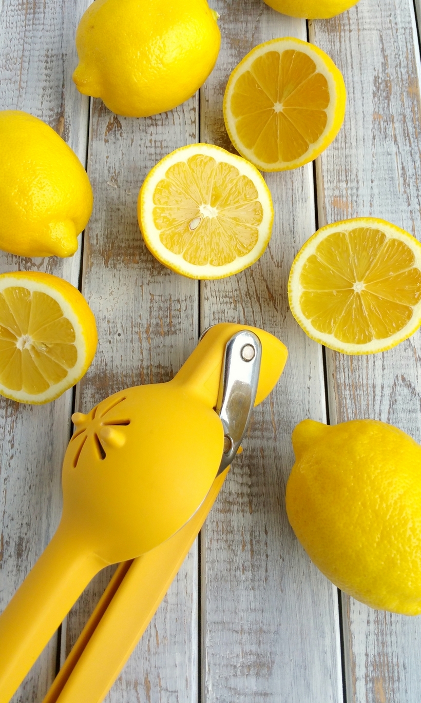 The perfect lemon drop martini should be refreshingly tart, not cloyingly sweet. Lucky for you this is The Most Refreshing Lemon Drop Martini! Give it a try soon. Yellow citrus squeezer with whole and sliced lemons.
