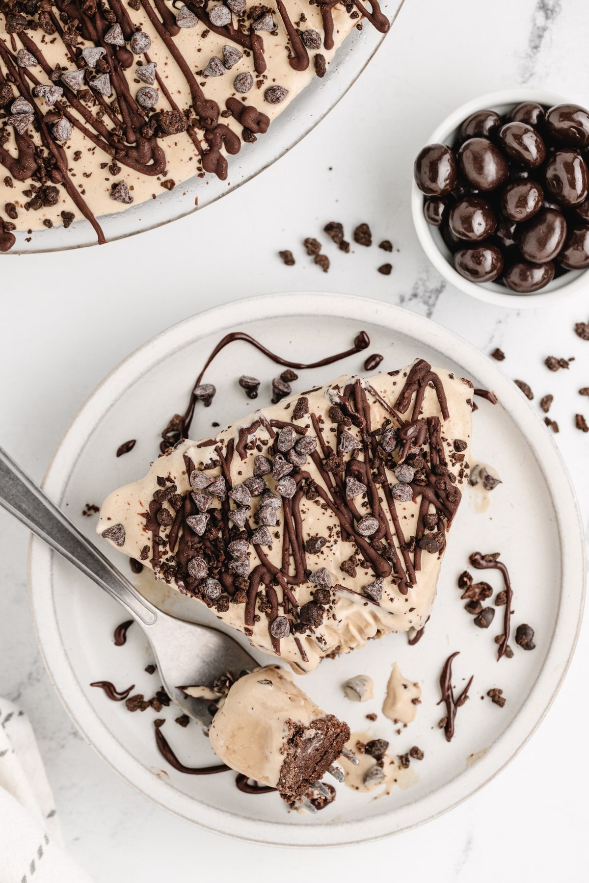 This Mud Pie is a real treat! Coffee-flavored ice cream and chocolate come together for a fantastic combo in every bite. I like to crush up some chocolate-covered espresso beans on top for an extra burst of flavor and a nice crunch. frozen mud pie