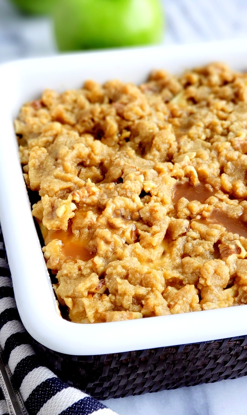 An easy apple crumble recipe you will not be able to resist! The crunchy walnut crumble topping, drizzled with caramel, makes this apple dessert and crumble recipe a winning combination. Baked apple crumble.