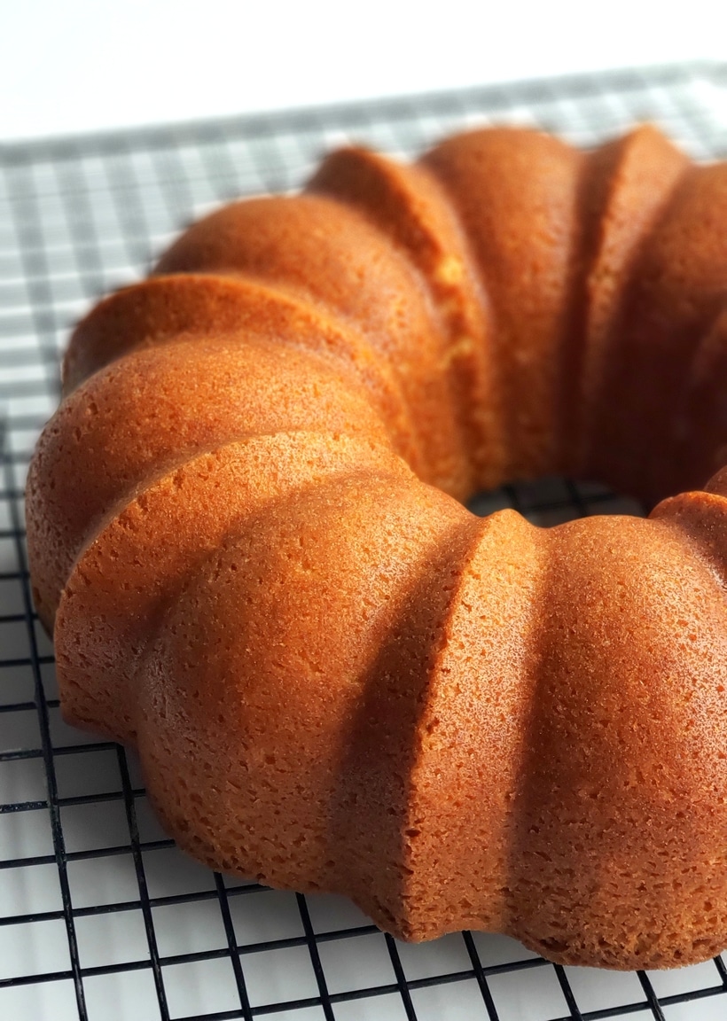 RumChata Bundt Cake on a cooling rack. Baked RumChata Bundt Cake on a cooling rack.