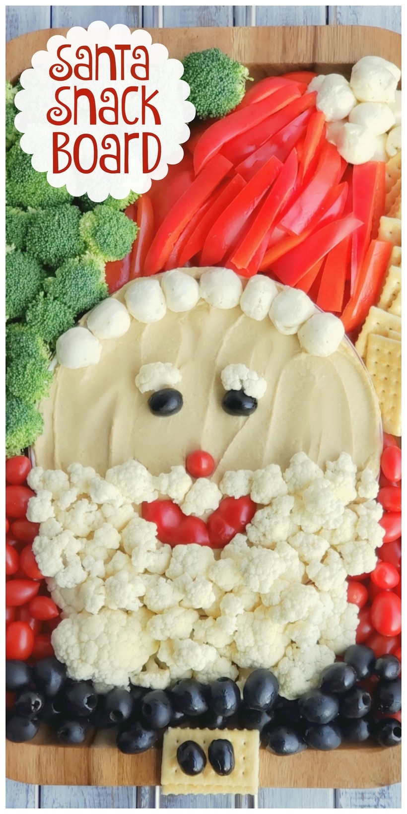 This Santa Snack Board is the perfect holiday centerpiece for every gathering this season. Not only is this healthy snack board festive and fun, it uses simple ingredients everyone loves. This Santa Board transports easily, feel free to take it along to every celebration this season. #noblepig #santasnackboard #diysantasnackboard #diy #healthysnackboard #christmas #christmasrecipes #easychristmasrecipes #holidayrecipes #santafood #santa #holidayentertaining #holidayfood #christmasappetizer Text overlay that reads Santa Snack Board and vegetables made to look like Santa.