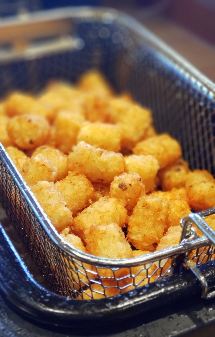 Tater in a deep fryer basket.