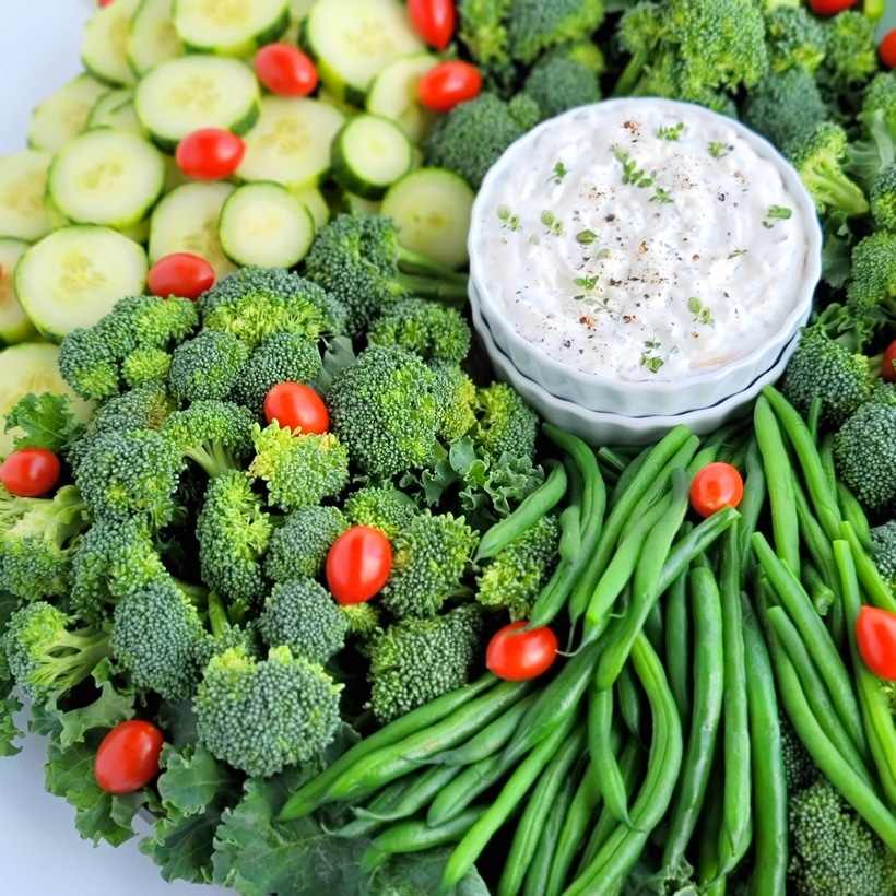 A simple Christmas Wreath Vegetable tray made from your favorite veggies and served with a tasty, addictive onion dip! wreath vegetable tray