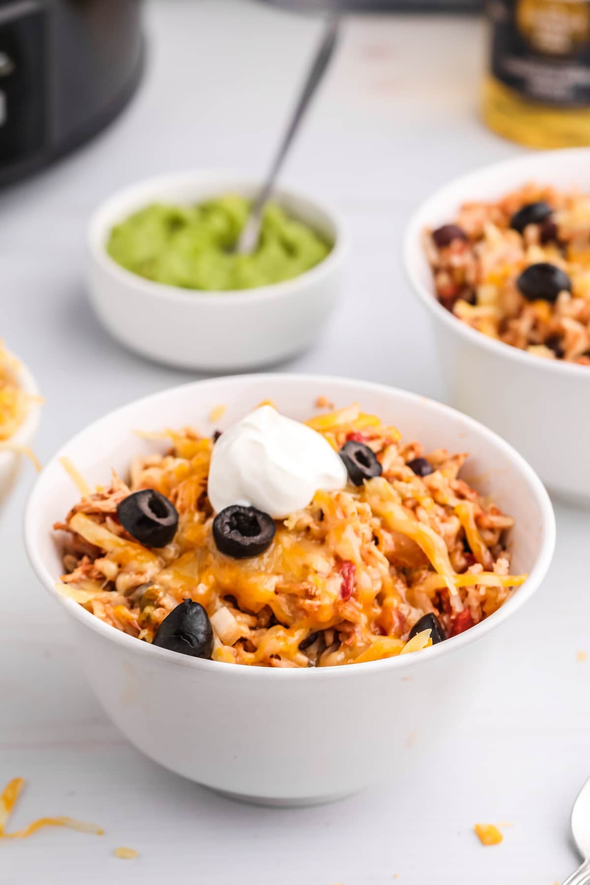 Slow Cooker Chicken Burrito Bowls cook chicken, black beans, salsa, tomatoes and green chiles in the Crockpot before shredded chicken and instant rice finish in the seasoned cooking liquid. The rice absorbs all that chile and tomato flavor right in the slow cooker, so there’s no separate pot of rice to make. Finish the bowls with melted Colby-Jack, avocado, sour cream, cilantro, lime, hot sauce or whatever toppings you like. making burrito bowls in the crockpot