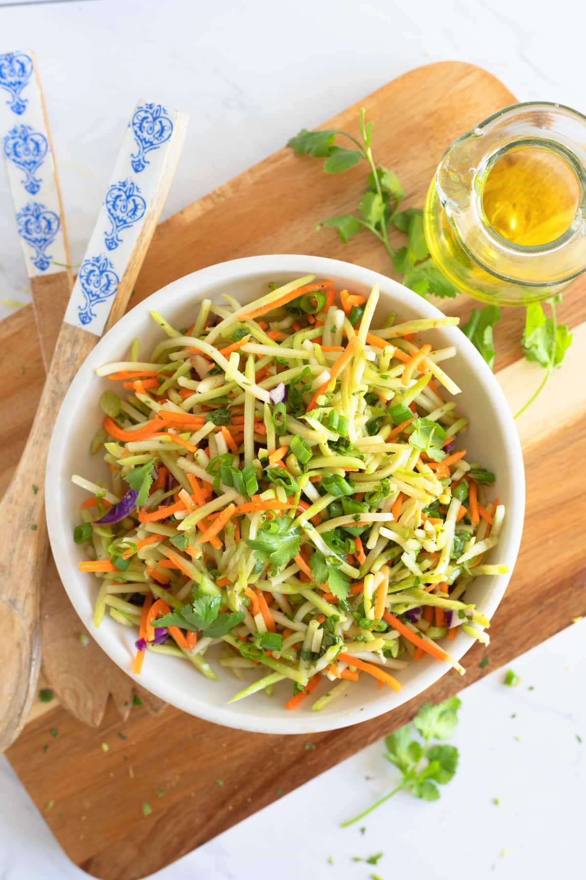 Cilantro lime broccoli slaw served in a bowl, topped with green onions and ready to enjoy.