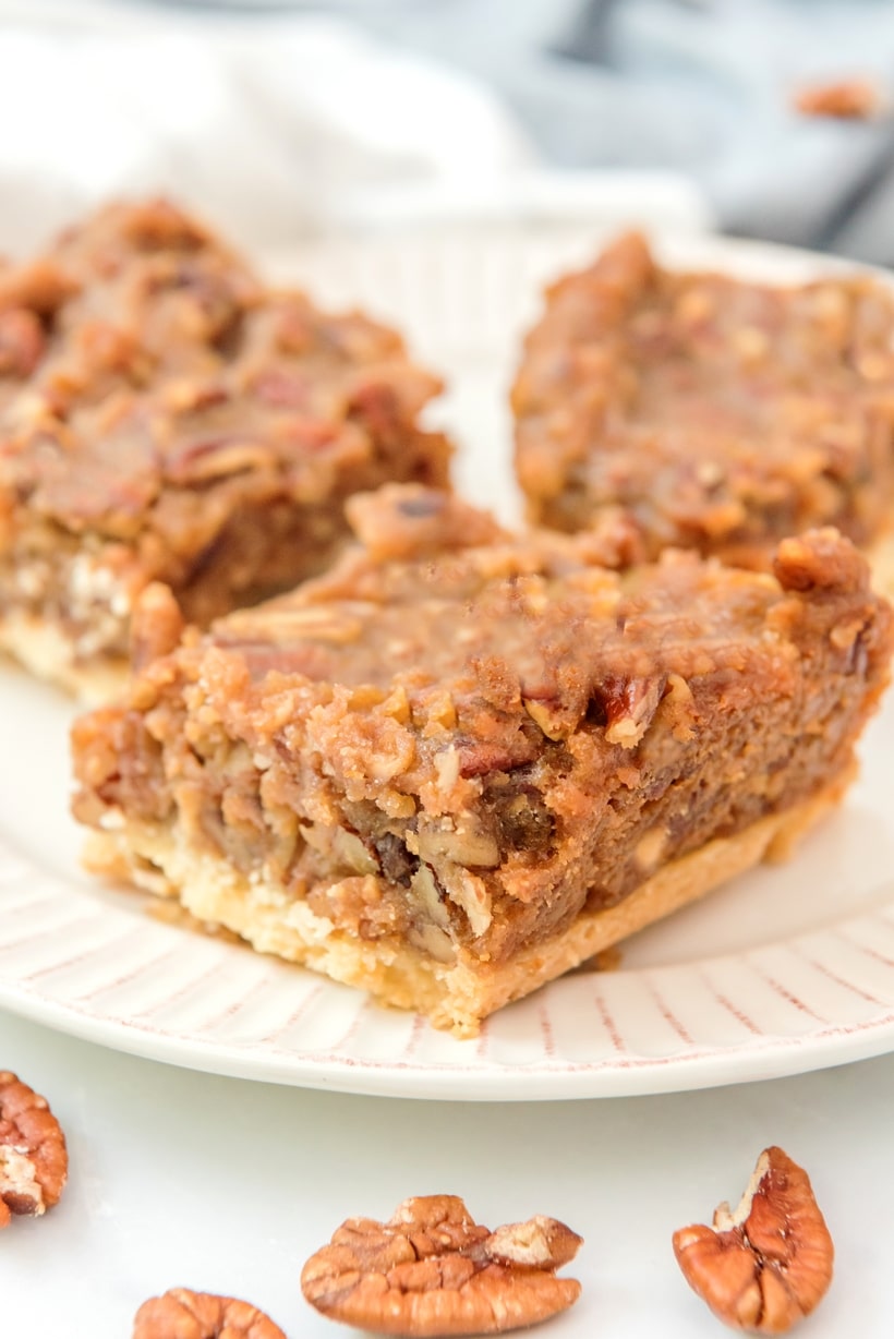 An easier way to enjoy pecan pie – these Pecan Pie Bars are bite-sized, with a short bread crust and made to serve a crowd. No pie skills necessary! pecan pie bars recipe