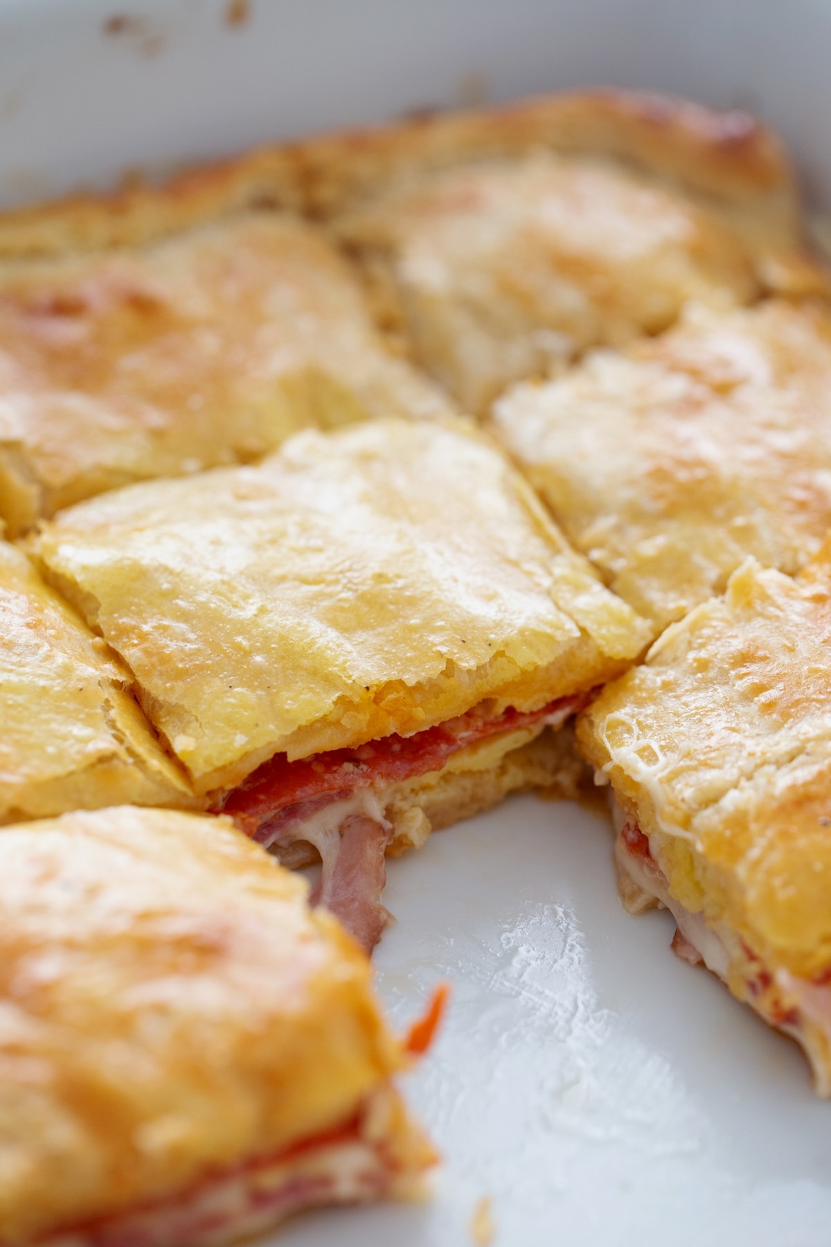 a baking tray of baked antipasto squares